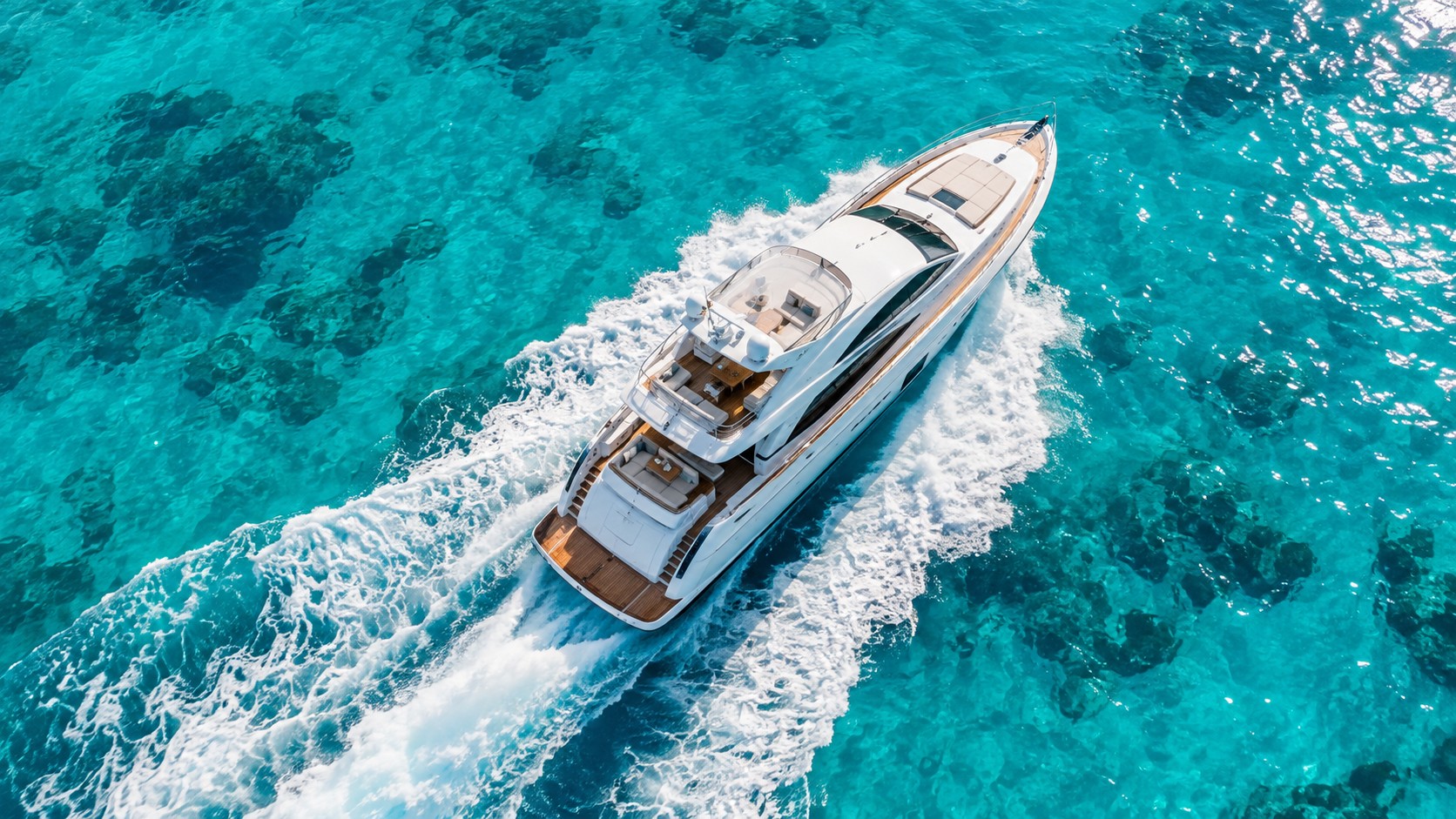 Motor yacht from above over clear water